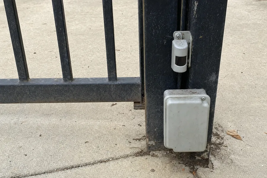 Gate operator, arm and control box on a driveway gate in Lincoln, NE