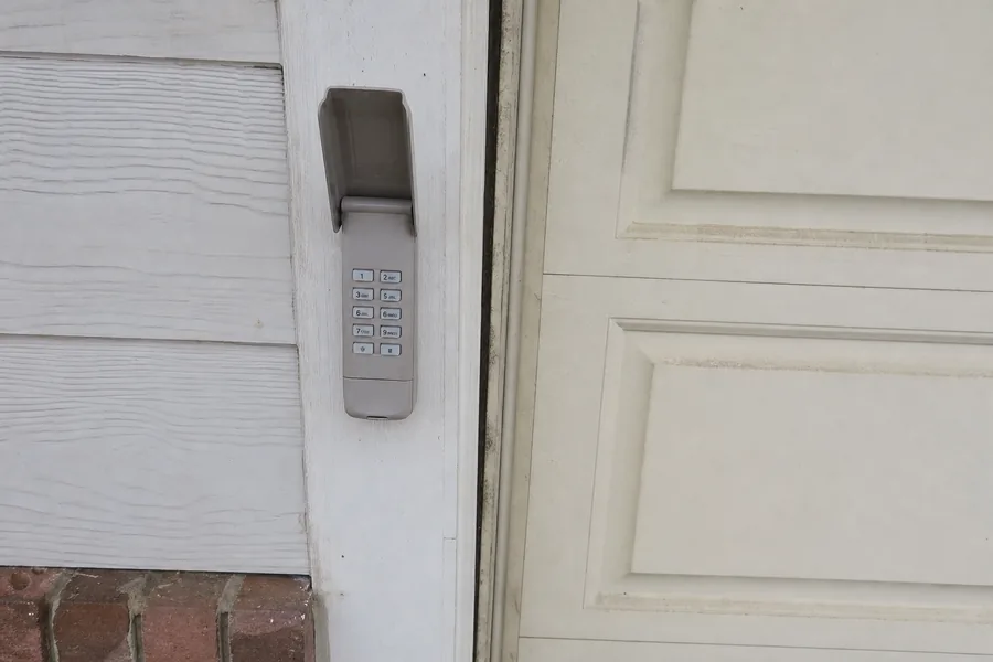 Hinges and roller along a panel seam of a garage door in Lincoln, NE
